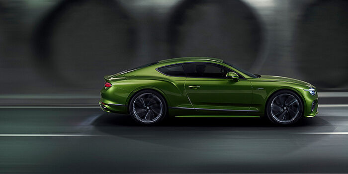  Bentley Tunbridge Wells Bentley Continental GT coupe in Tourmaline Green paint driving in profile on a dark road