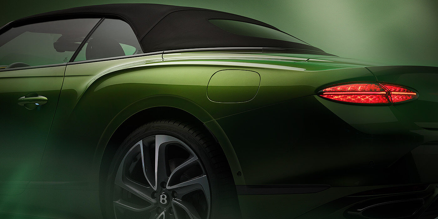 Bentley Tunbridge Wells Bentley New Continental GTC Speed rear haunch and tail lamp in Tourmaline Green paint and dark tint brightware with black hood up and illuminated head lamps