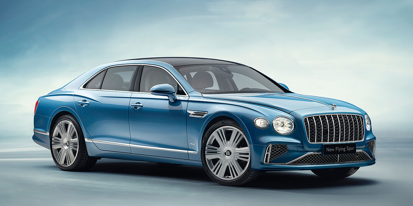 Bentley Tunbridge Wells New Bentley Flying Spur Azure sedan front view in Light windsor blue by Mulliner paint with 22 inch Azure wheels and chrome exterior details
